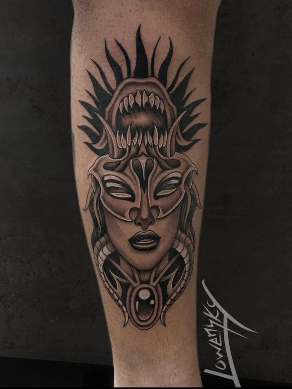Black and grey fine line calf tattoo of a demon woman portrait with teeth by tattoo artist Lowensky Santiago of Sacred Mandala Studio in Durham, NC.